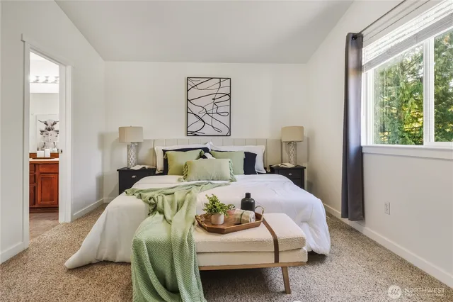 a bed sitting in a bedroom next to a window