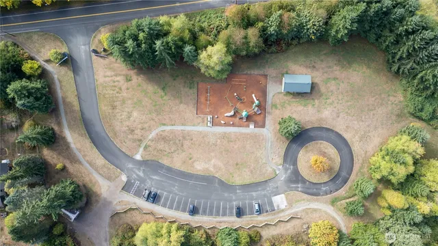 an aerial view of a house with garden space and swimming pool
