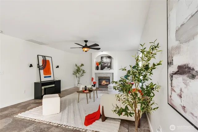 a living room with furniture flowers and flower pot