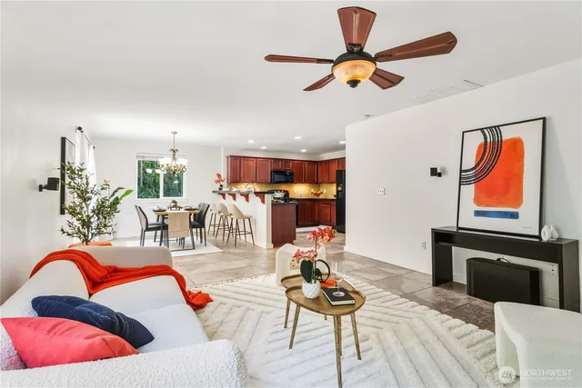 a living room with furniture and kitchen view