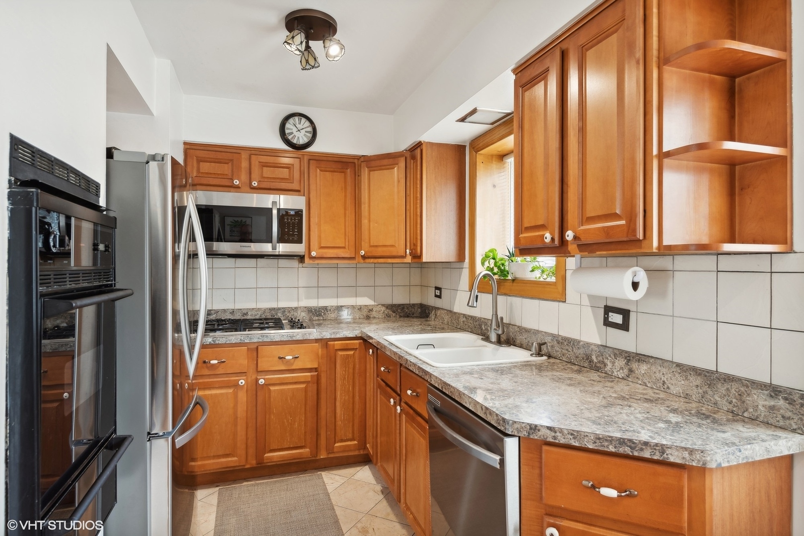1127 West Erie Street, Unit 1C Chicago, IL 60642 - Photo 11 of 18 a kitchen with stainless steel appliances granite countertop a sink a stove cabinets and a refrigerator