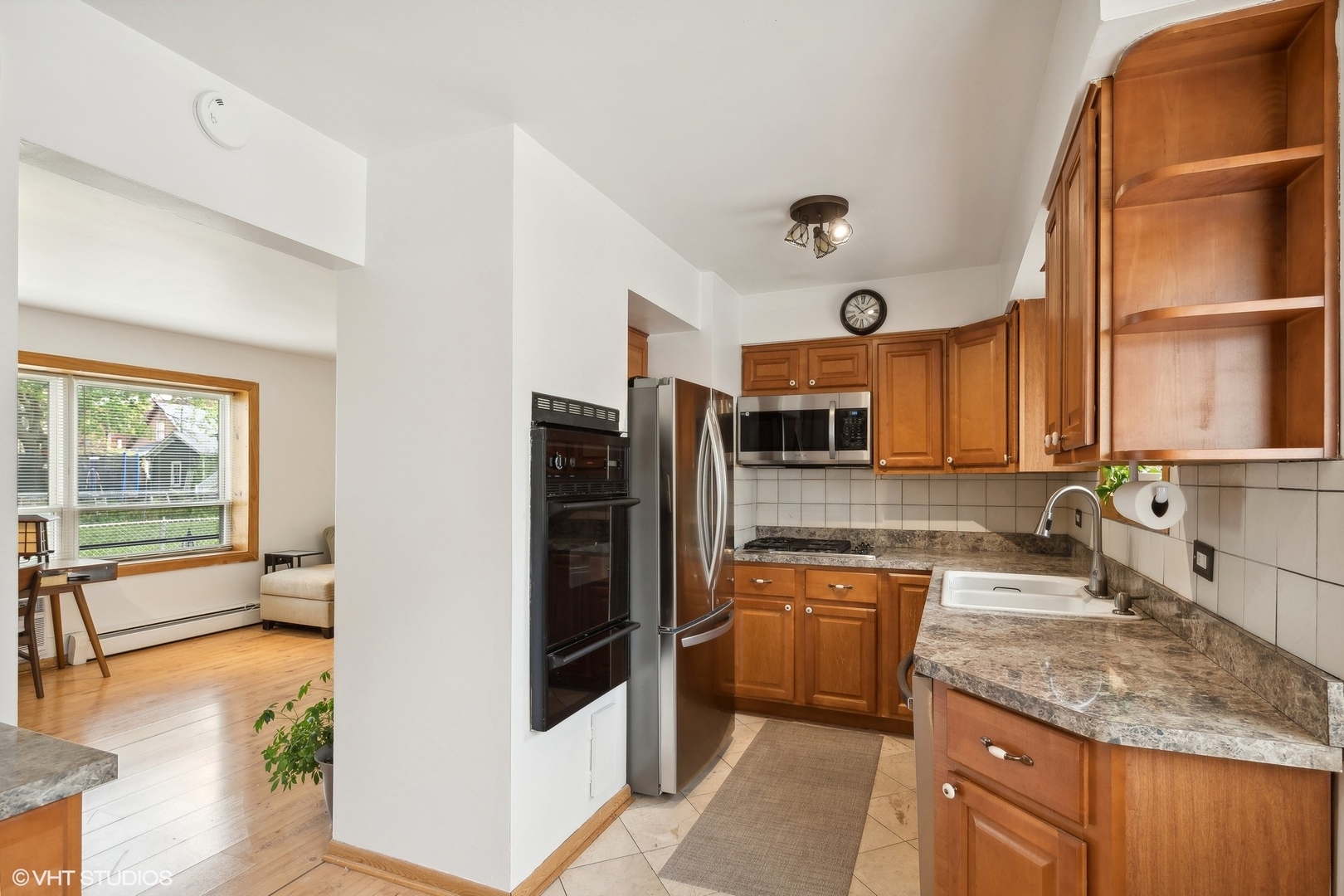1127 West Erie Street, Unit 1C Chicago, IL 60642 - Photo 12 of 18 a kitchen with granite countertop a sink and a refrigerator