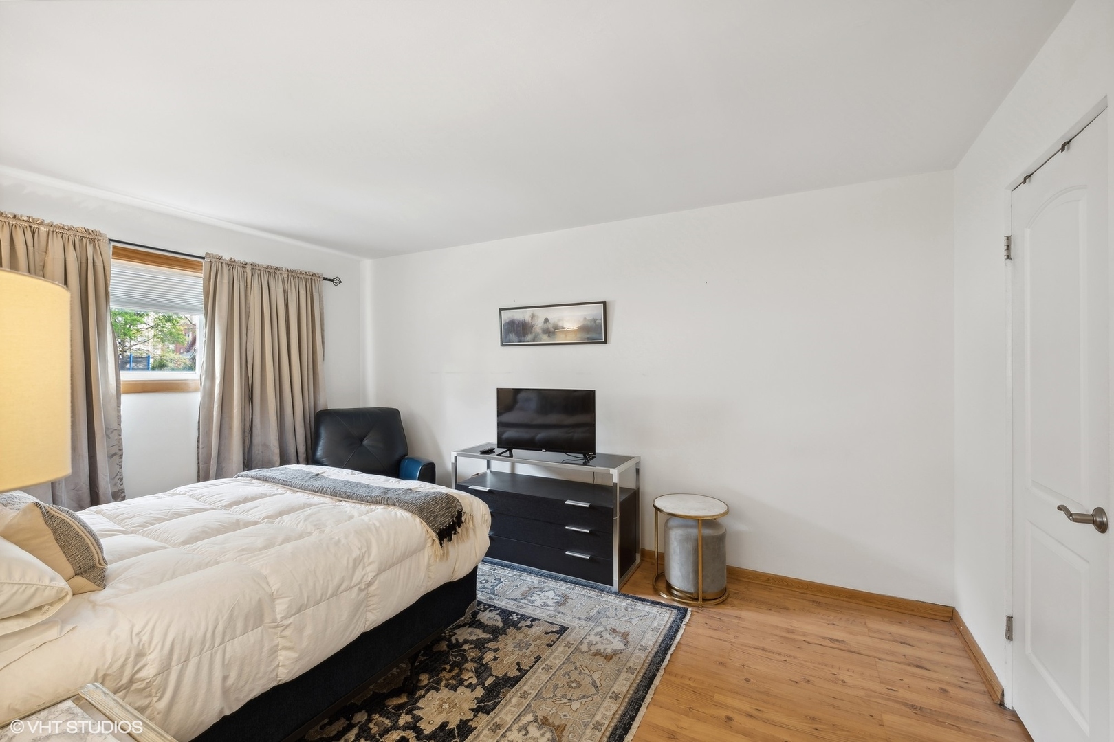 1127 West Erie Street, Unit 1C Chicago, IL 60642 - Photo 15 of 18 a bedroom with a bed and a tv