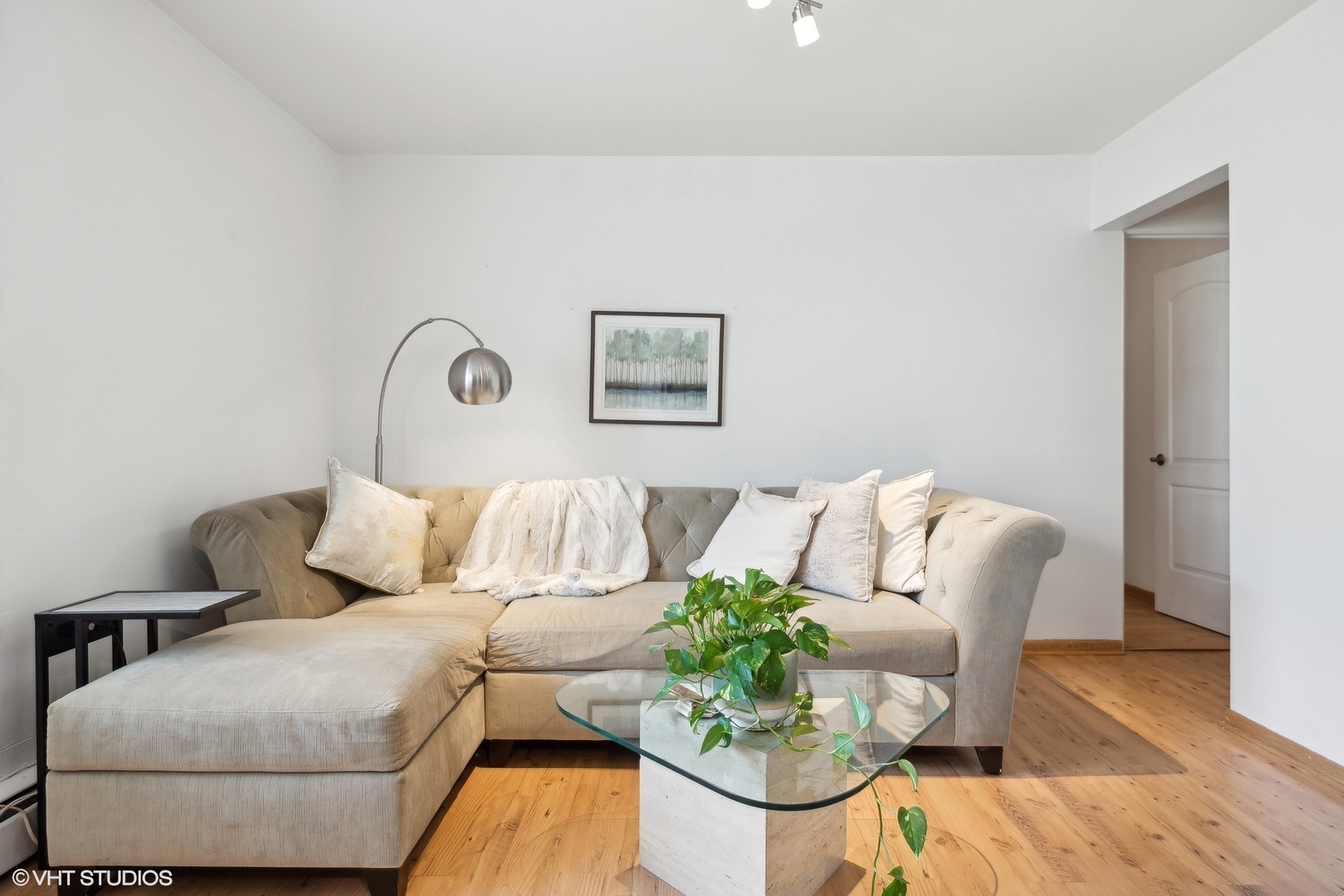 1127 West Erie Street, Unit 1C Chicago, IL 60642 - Photo 7 of 18 a living room with furniture and wooden floor