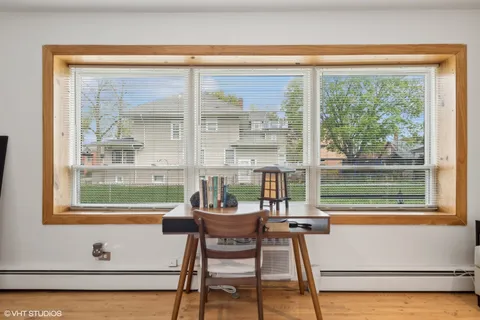a living room with furniture and a flat screen tv with wooden floor