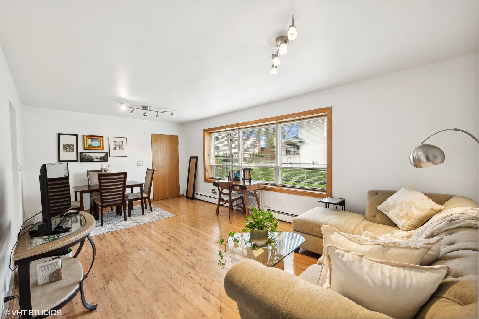 1127 West Erie Street, Unit 1C Chicago, IL 60642 - Photo 9 of 18 a living room with furniture and a flat screen tv with wooden floor