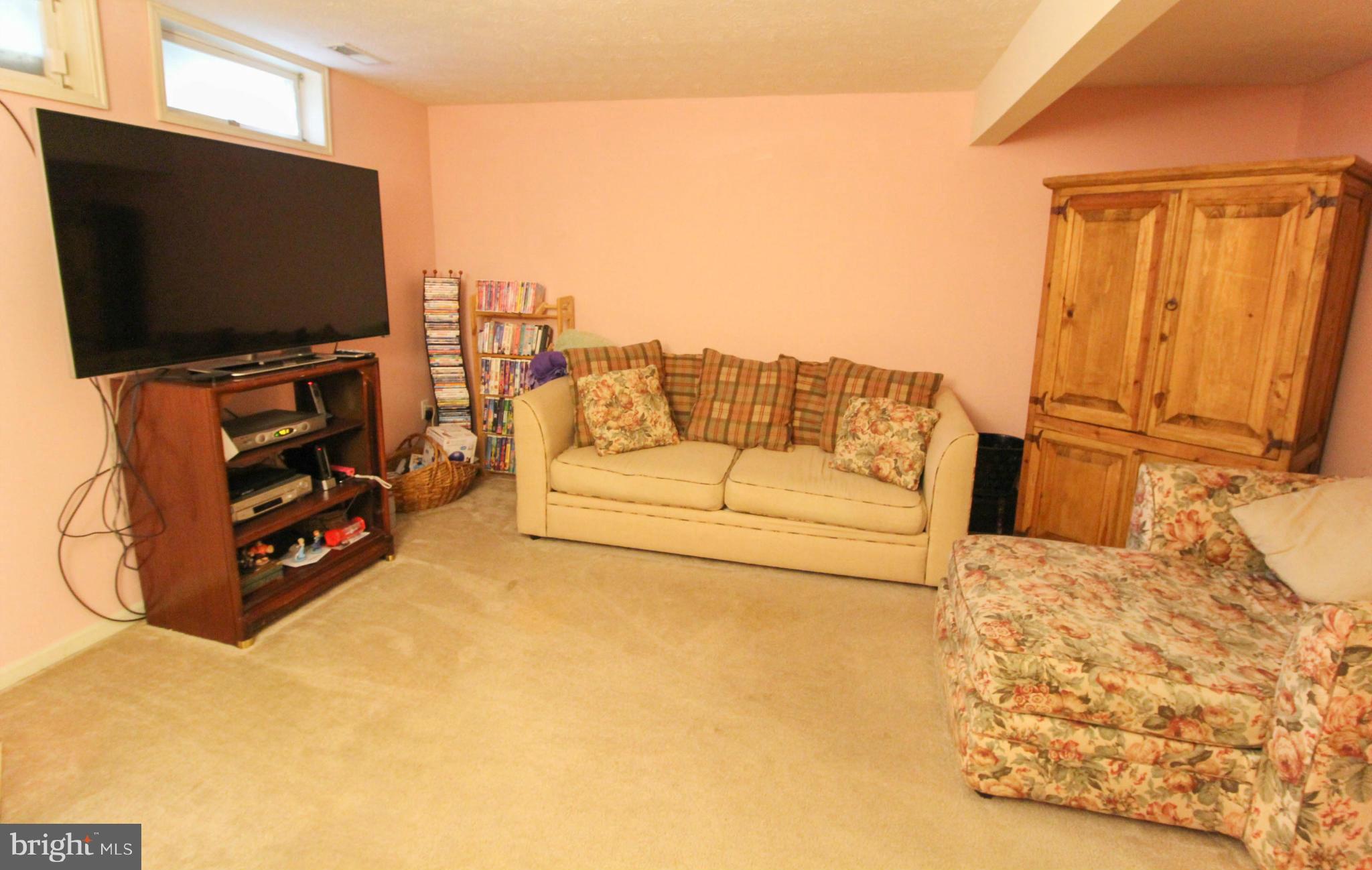 2242 Riding Crop Way Baltimore, MD 21244 - Photo 12 of 20 a living room with furniture and a flat screen tv