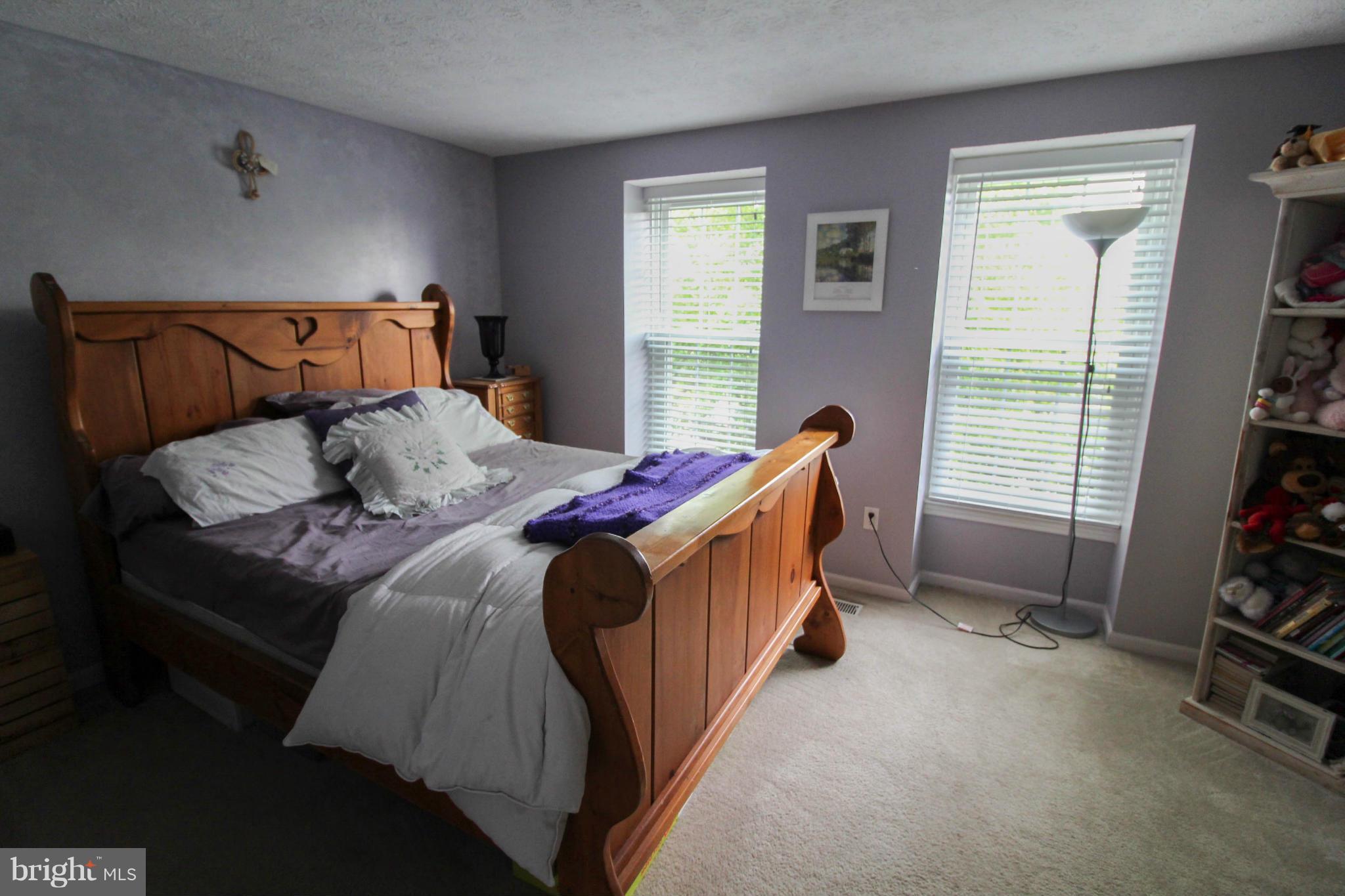 2242 Riding Crop Way Baltimore, MD 21244 - Photo 16 of 20 a bed sitting in a bedroom next to a window