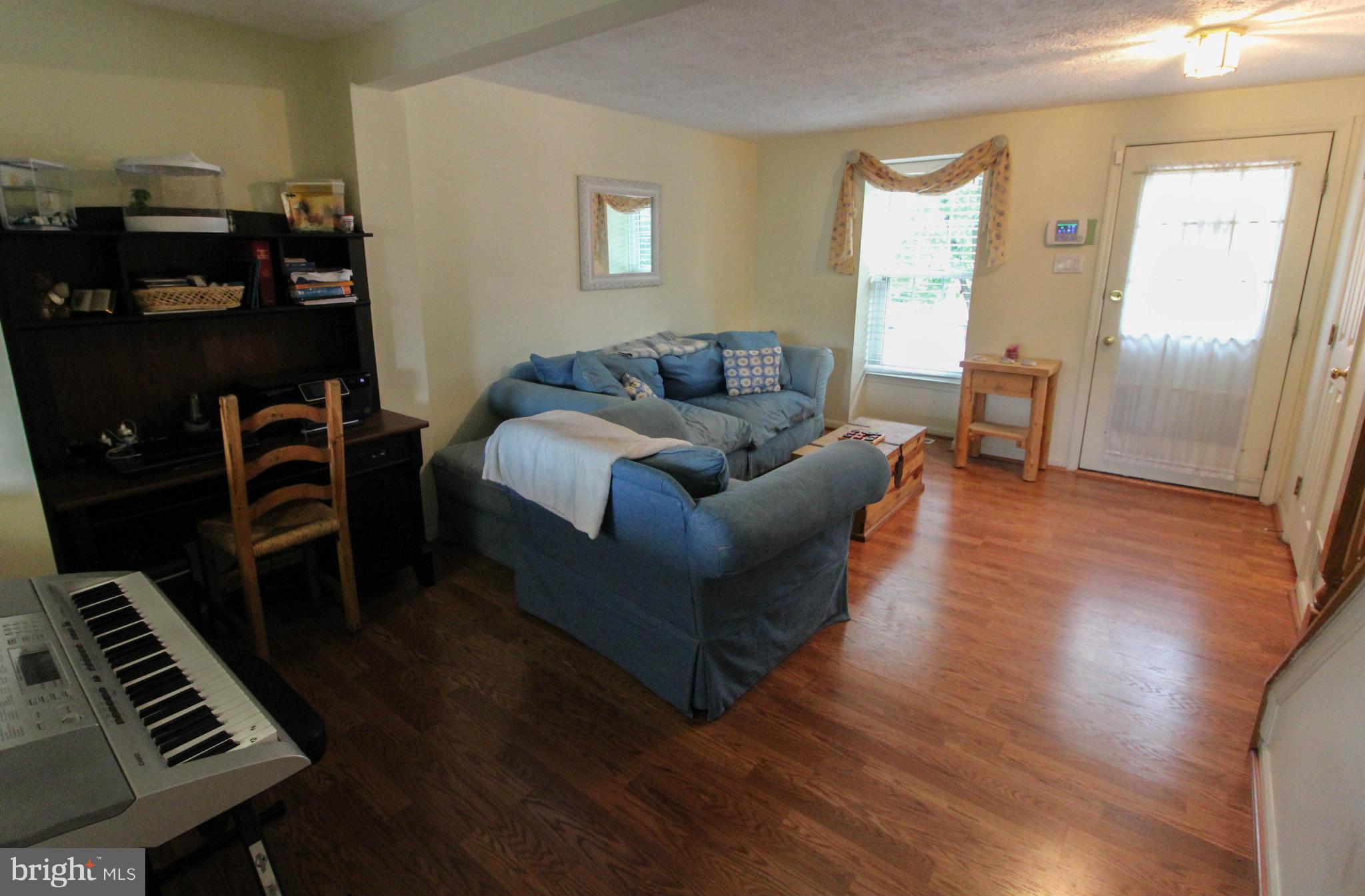 2242 Riding Crop Way Baltimore, MD 21244 - Photo 5 of 20 a living room with furniture and a piano