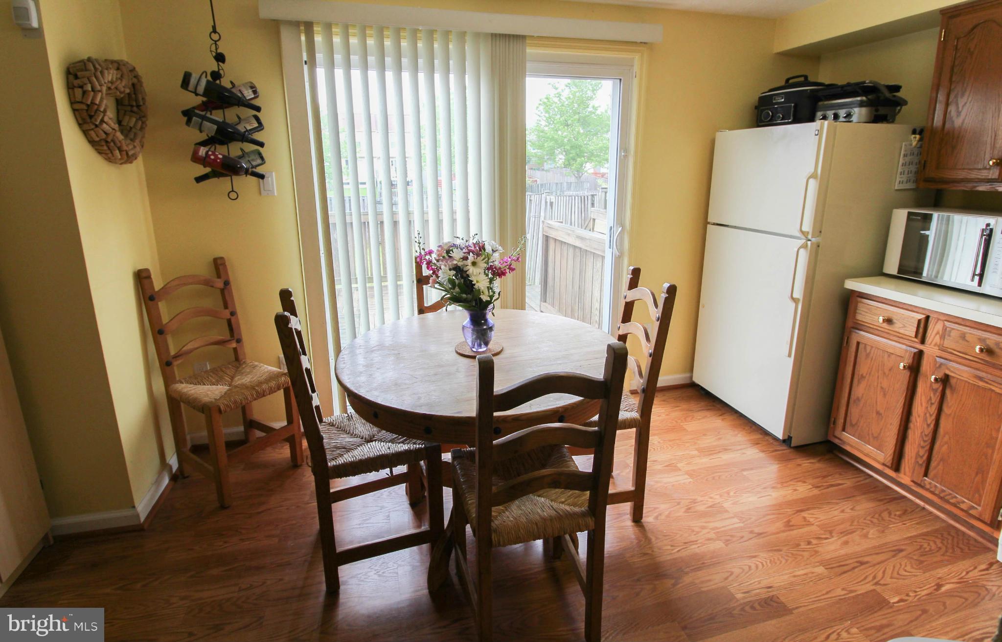 2242 Riding Crop Way Baltimore, MD 21244 - Photo 6 of 20 a view of a dining room with furniture and a window