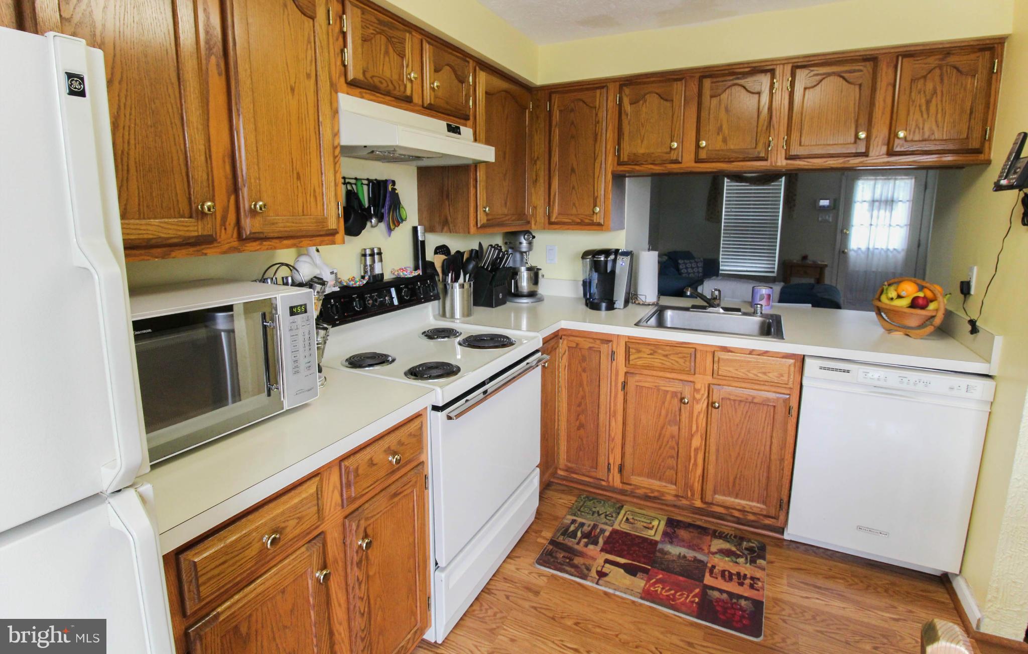 2242 Riding Crop Way Baltimore, MD 21244 - Photo 8 of 20 a kitchen with stainless steel appliances a stove a sink dishwasher and cabinets with wooden floor