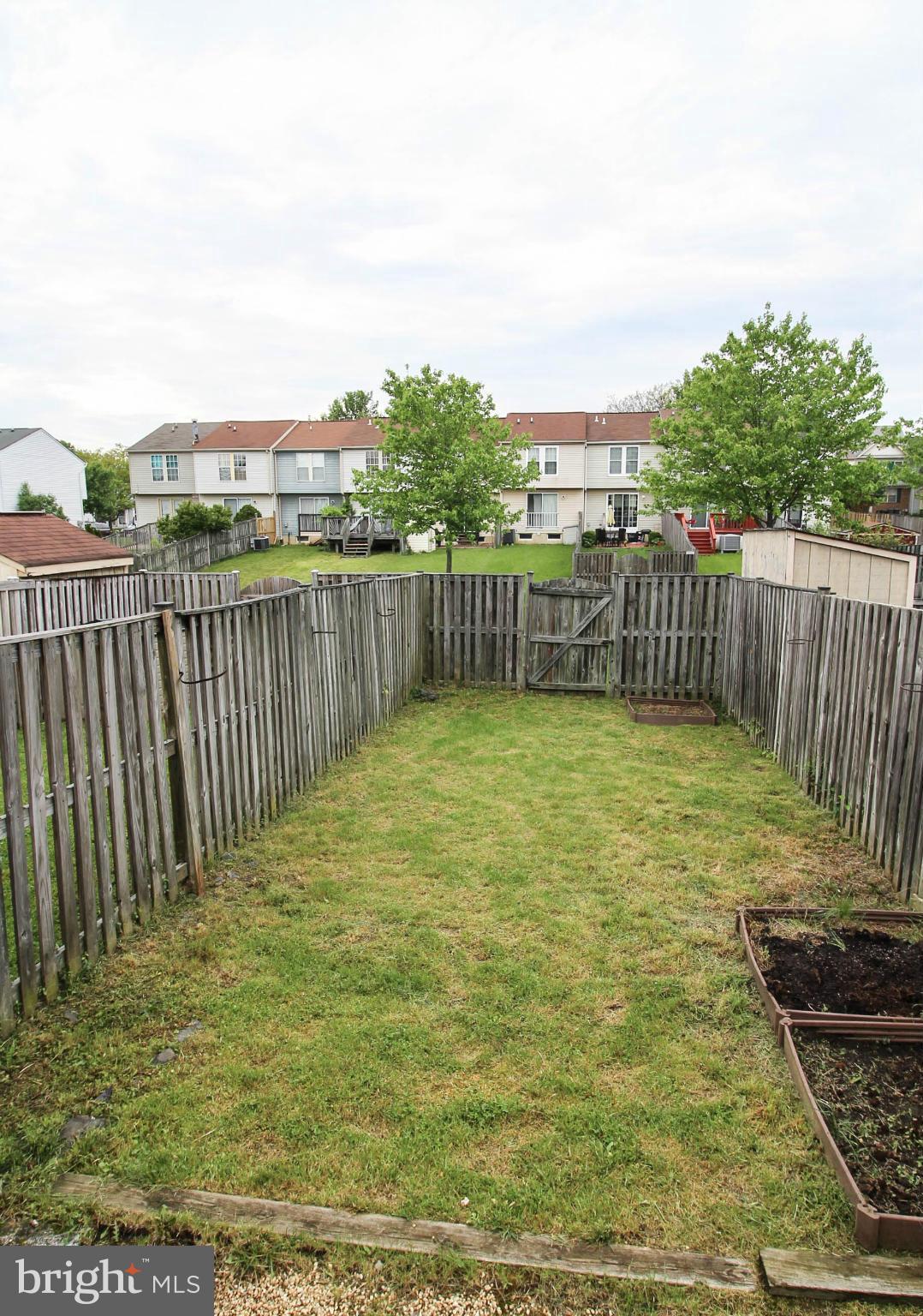2242 Riding Crop Way Baltimore, MD 21244 - Photo 10 of 20 a view of a yard with wooden fence