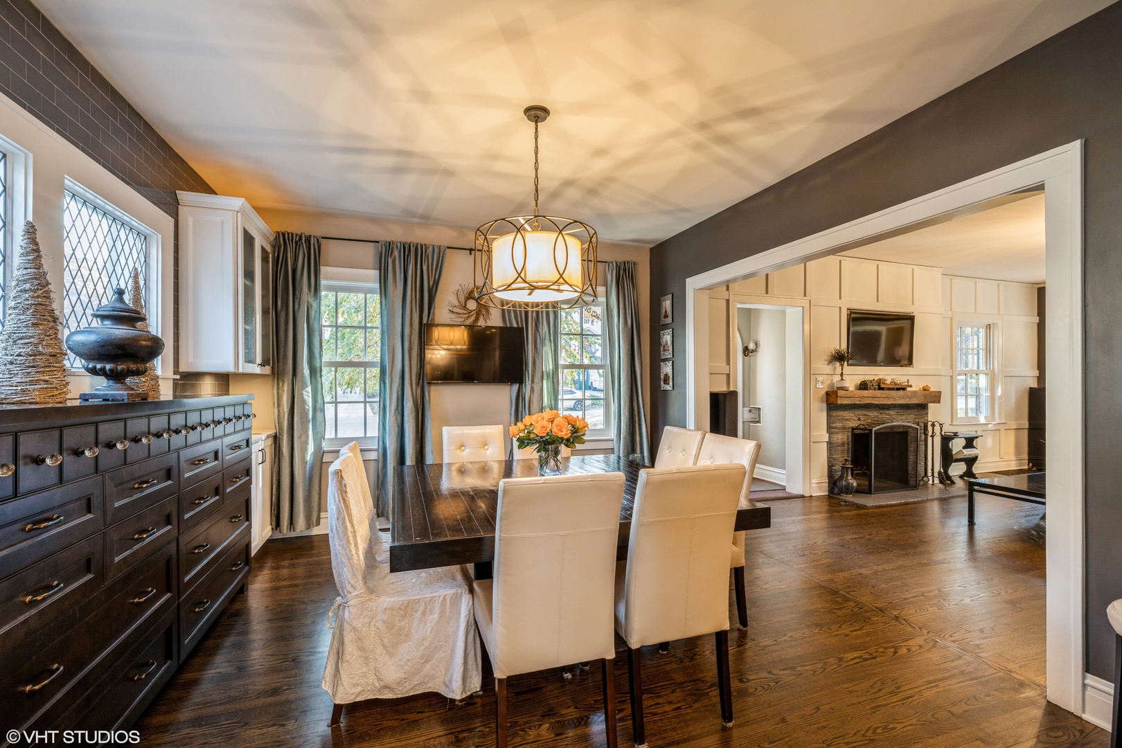 217 Ravine Road Hinsdale, IL 60521 - Photo 12 of 53 a dining room with wooden floor a chandelier a glass table and chairs