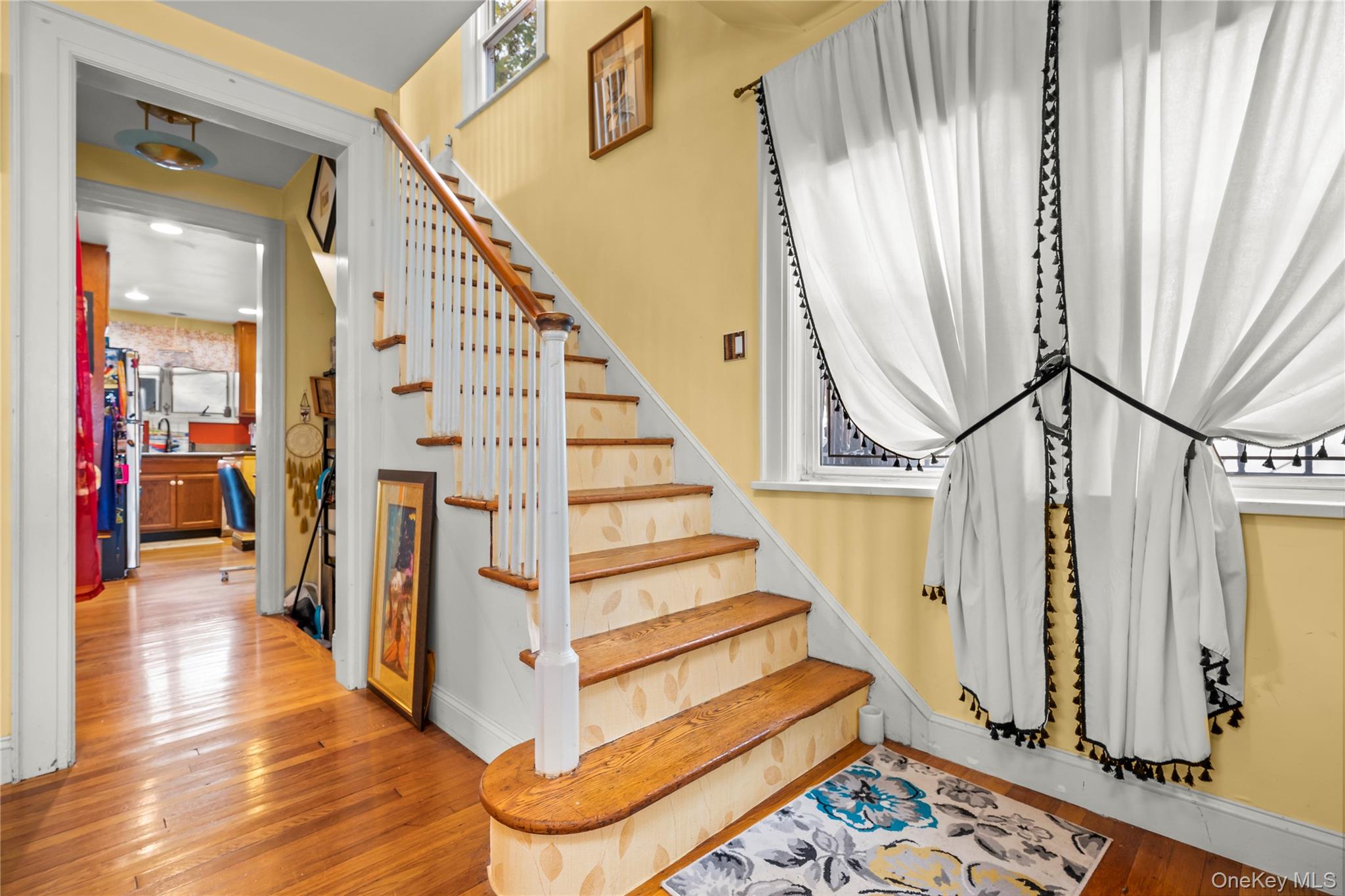112-45 178th Street Queens, NY 11433 - Photo 11 of 24 a view of entryway with wooden floor and stairs
