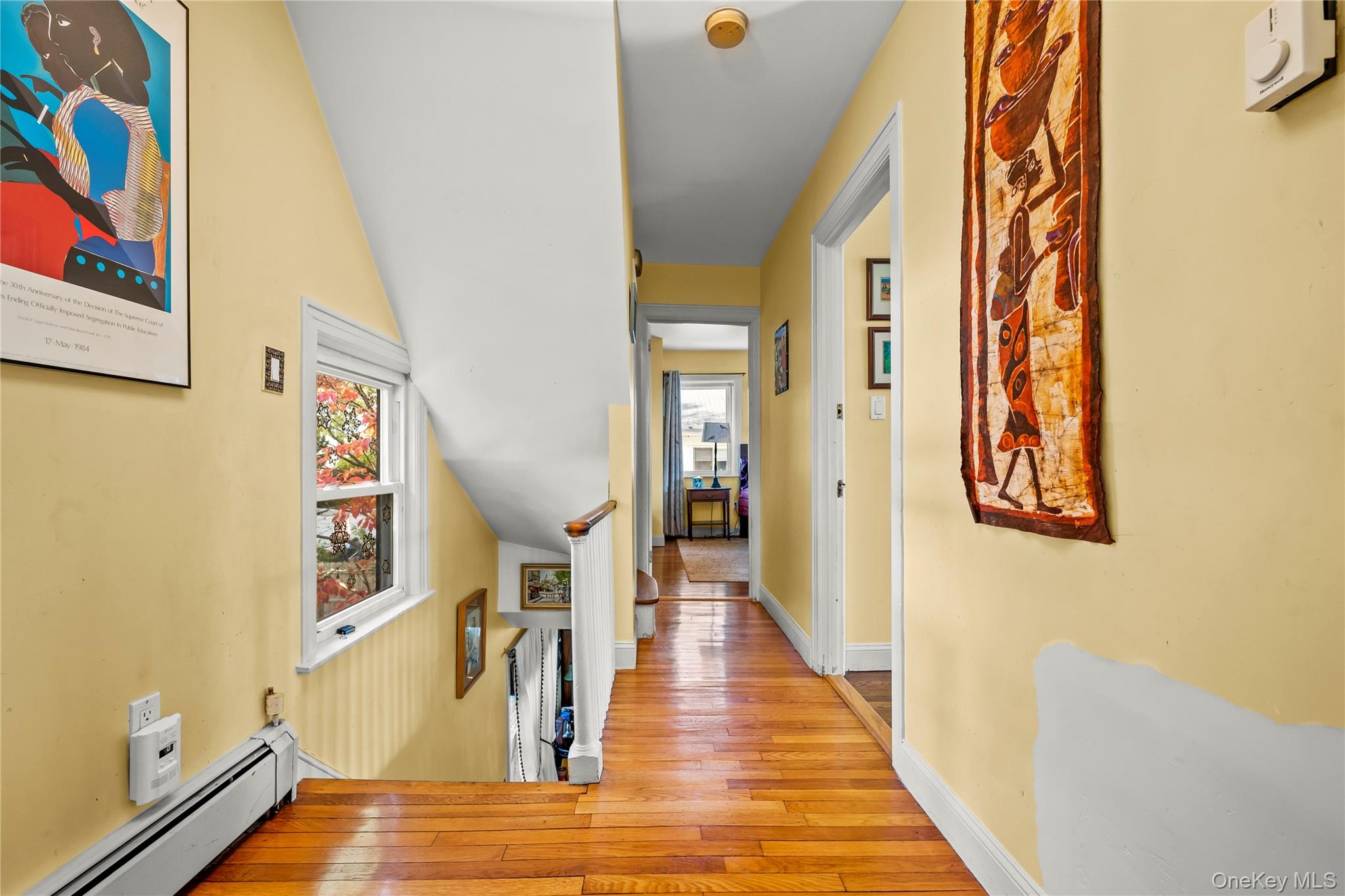 112-45 178th Street Queens, NY 11433 - Photo 12 of 24 a view of a hallway with wooden floor and staircase