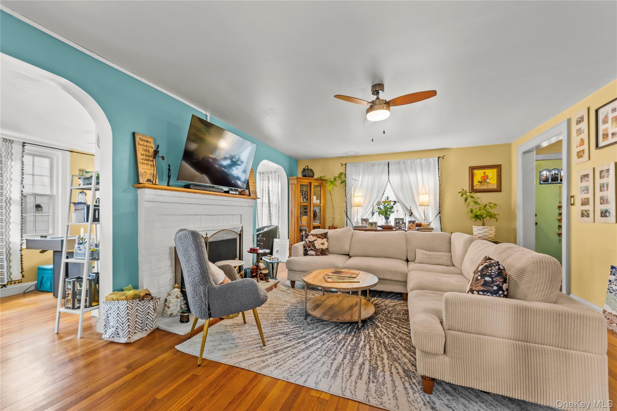 112-45 178th Street Queens, NY 11433 - Photo 5 of 24 a living room with furniture a fireplace and a table