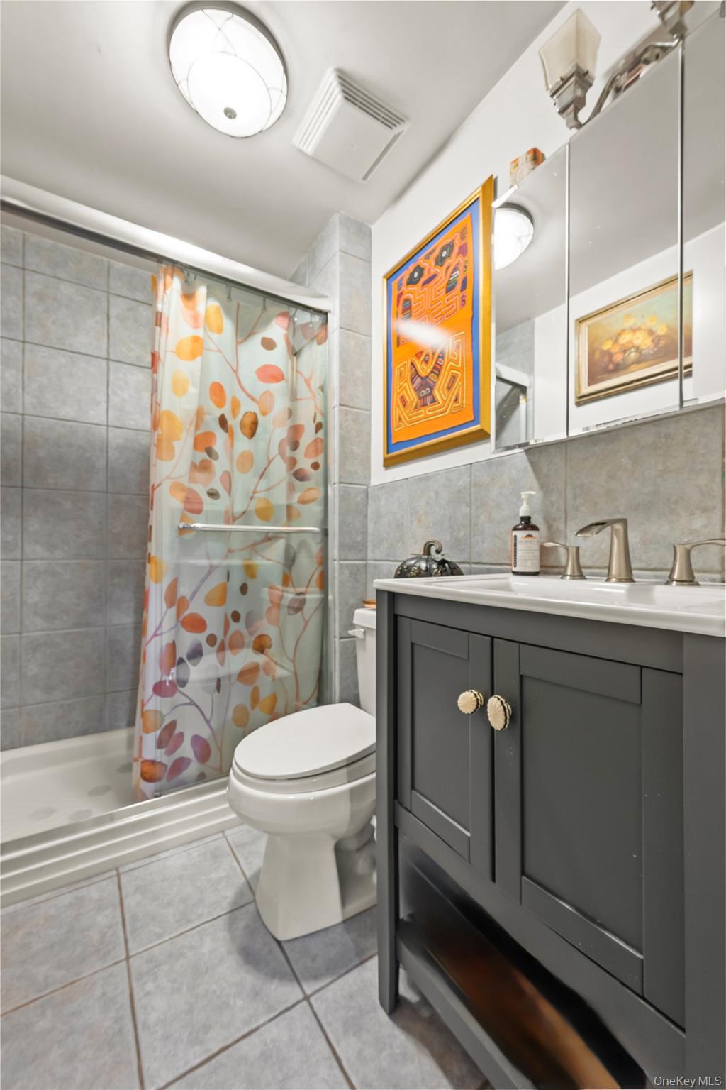 112-45 178th Street Queens, NY 11433 - Photo 10 of 24 a bathroom with a sink vanity mirror and toilet