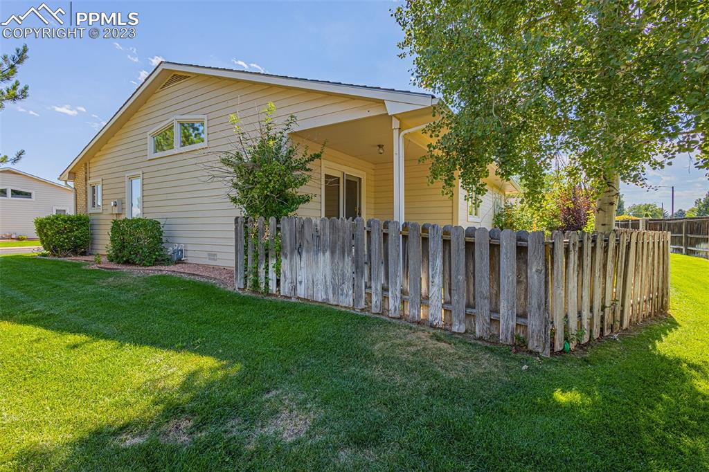 53 Sovereign Circle, Unit A Pueblo, CO 81005 - Photo 17 of 18 a front view of house with backyard and green space