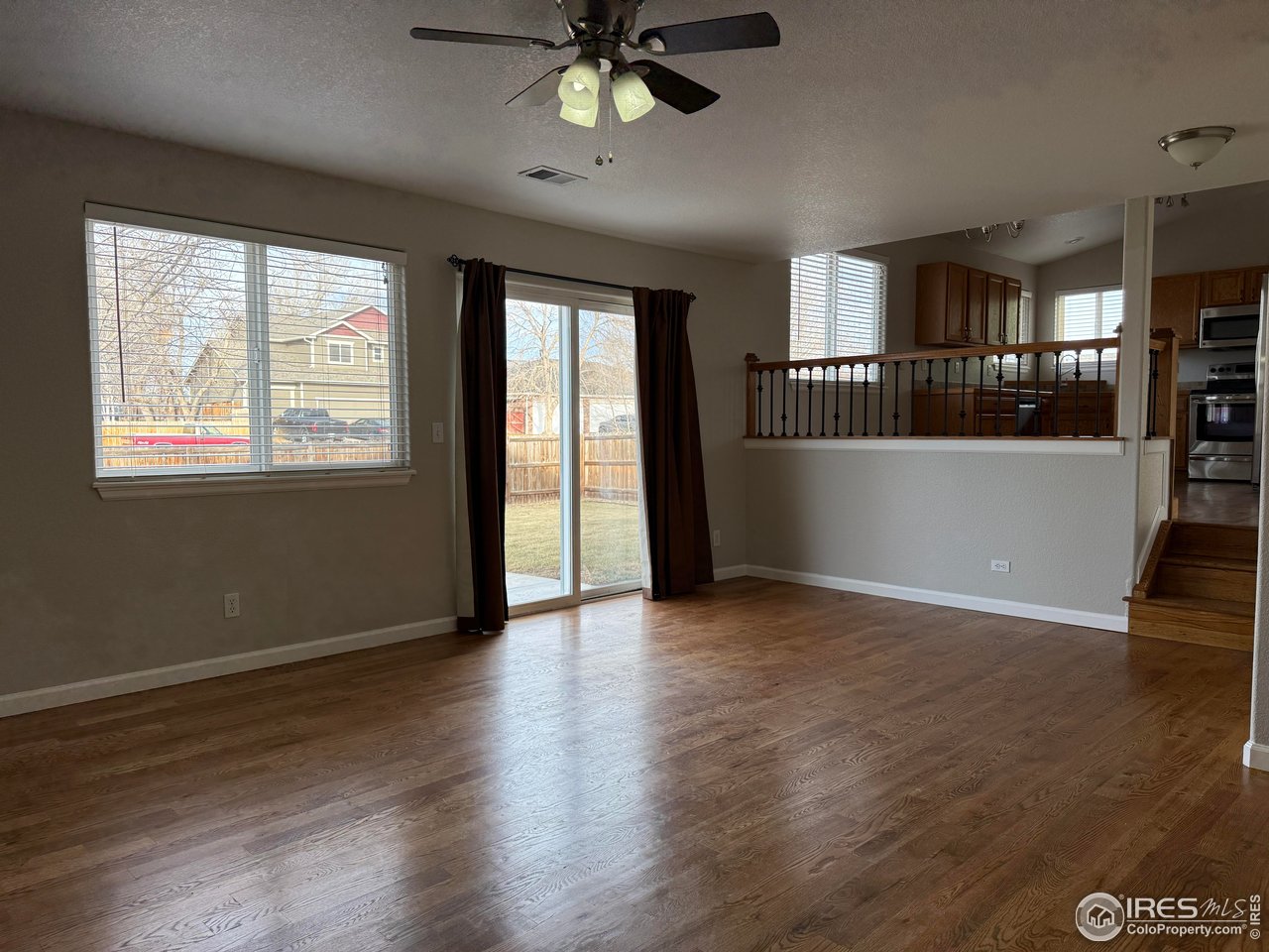 613 Sumac Street Frederick, CO 80530 - Photo 13 of 34 a view of an empty room with a window and wooden floor