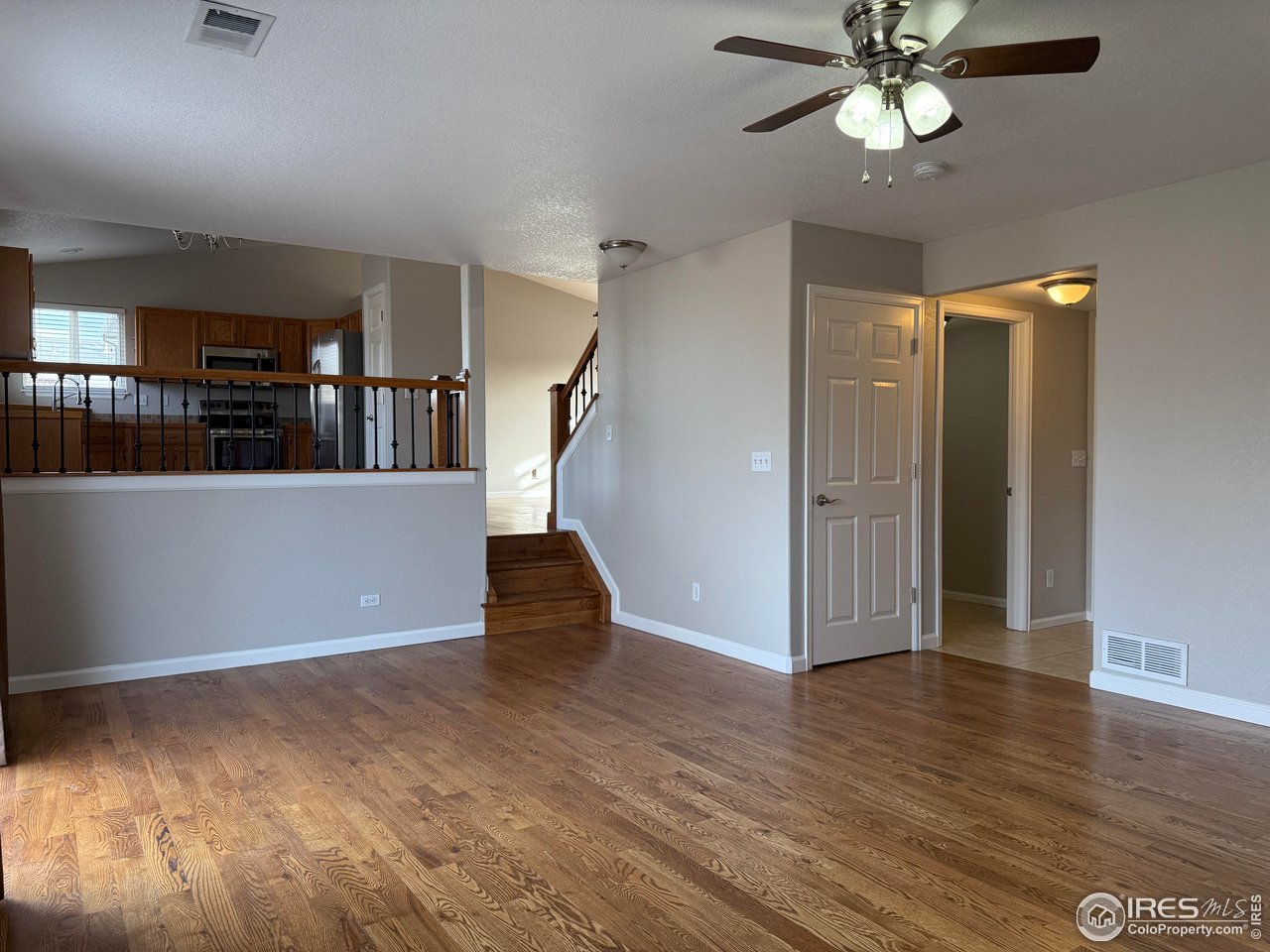 613 Sumac Street Frederick, CO 80530 - Photo 14 of 34 a view of empty room with wooden floor and fan