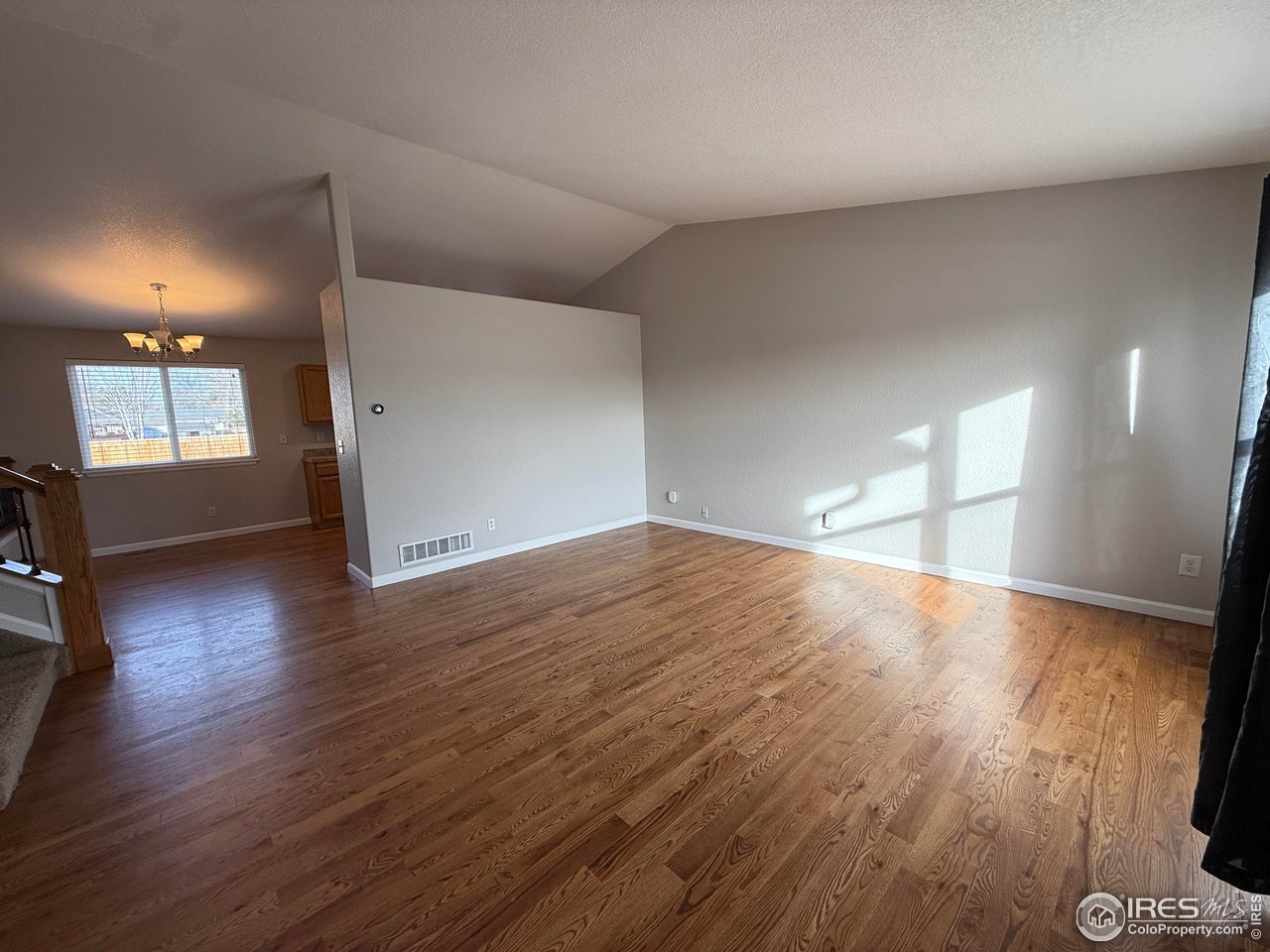 613 Sumac Street Frederick, CO 80530 - Photo 17 of 34 an empty room with wooden floor and windows