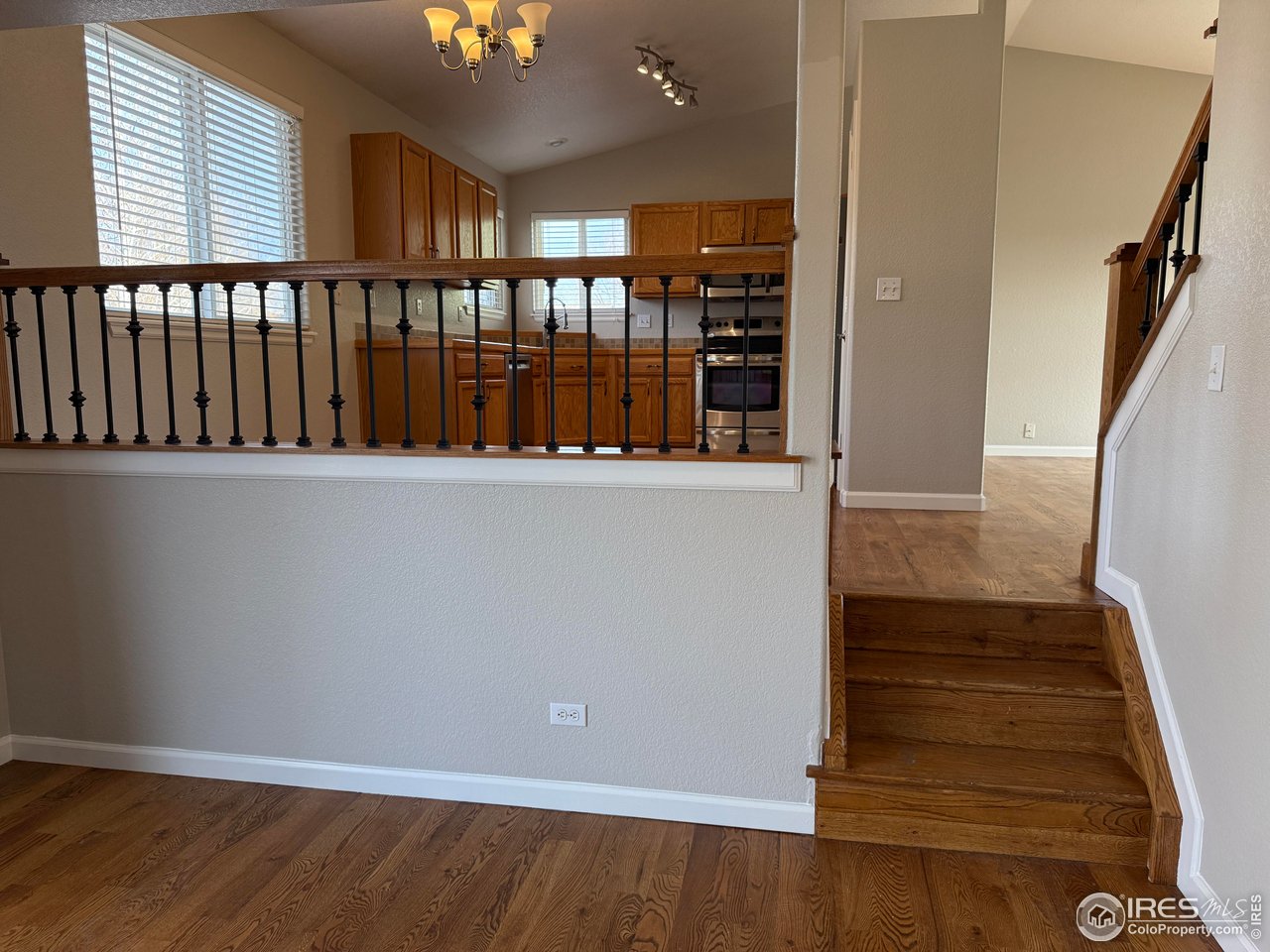 613 Sumac Street Frederick, CO 80530 - Photo 20 of 34 a view of a hallway with wooden floor and staircase