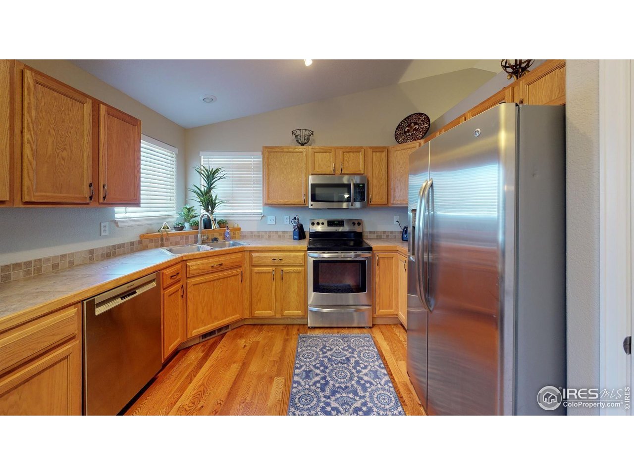 613 Sumac Street Frederick, CO 80530 - Photo 30 of 34 a kitchen with stainless steel appliances a sink and cabinets