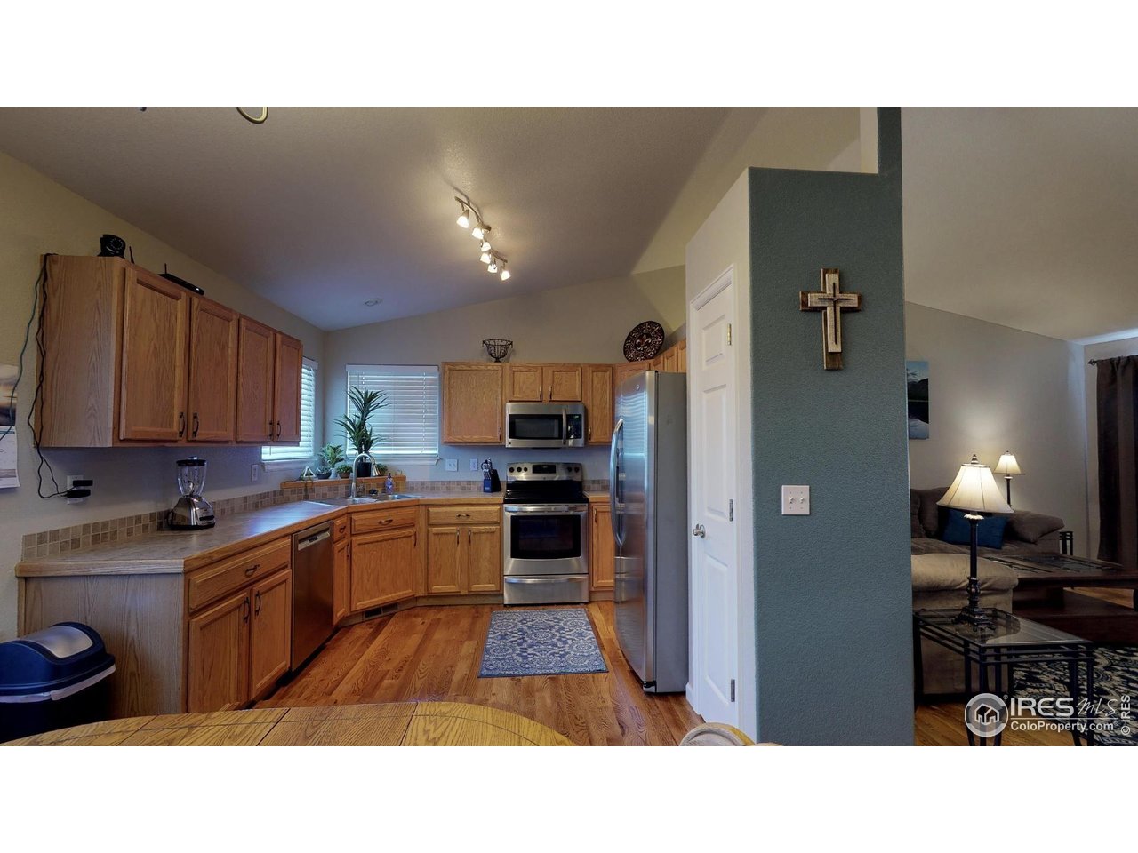 613 Sumac Street Frederick, CO 80530 - Photo 3 of 34 a open kitchen with cabinets and stainless steel appliances