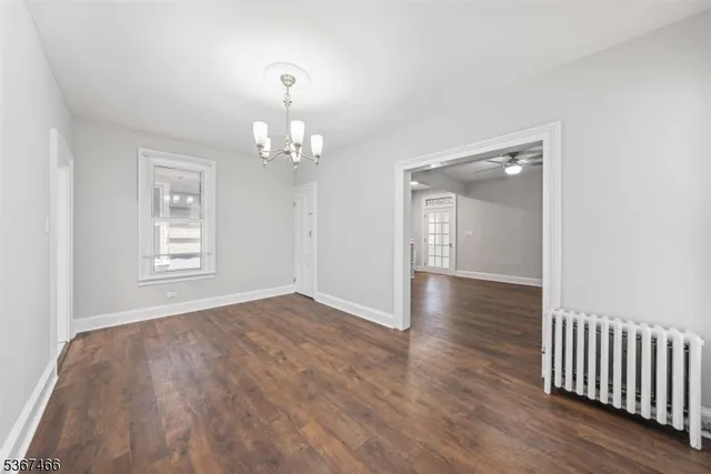 a view of livingroom with hallway and wooden floor