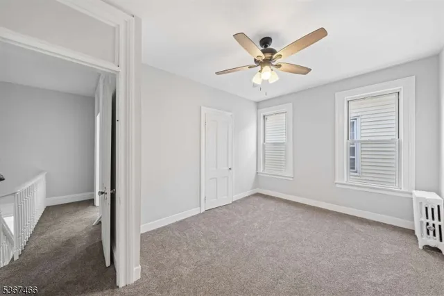 a view of a livingroom with a ceiling fan and window