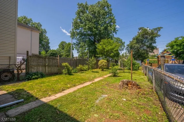 a view of a backyard with swimming pool