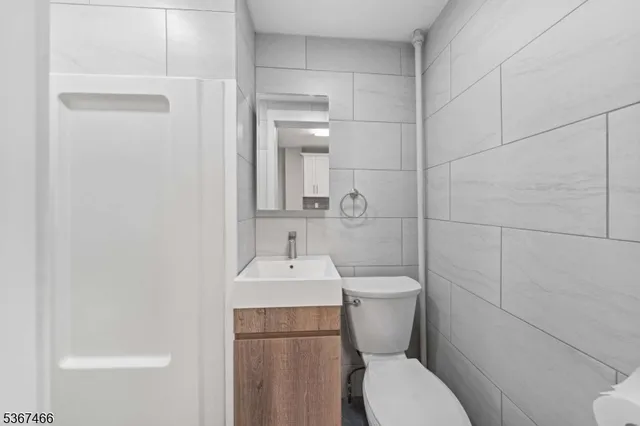 a white toilet sitting next to a bathroom sink