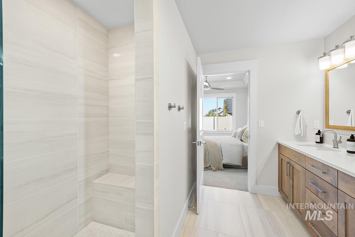 6983 South Skybreak Lane Meridian, ID 83642 - Photo 10 of 25 Ensuite bathroom featuring vanity and tiled shower