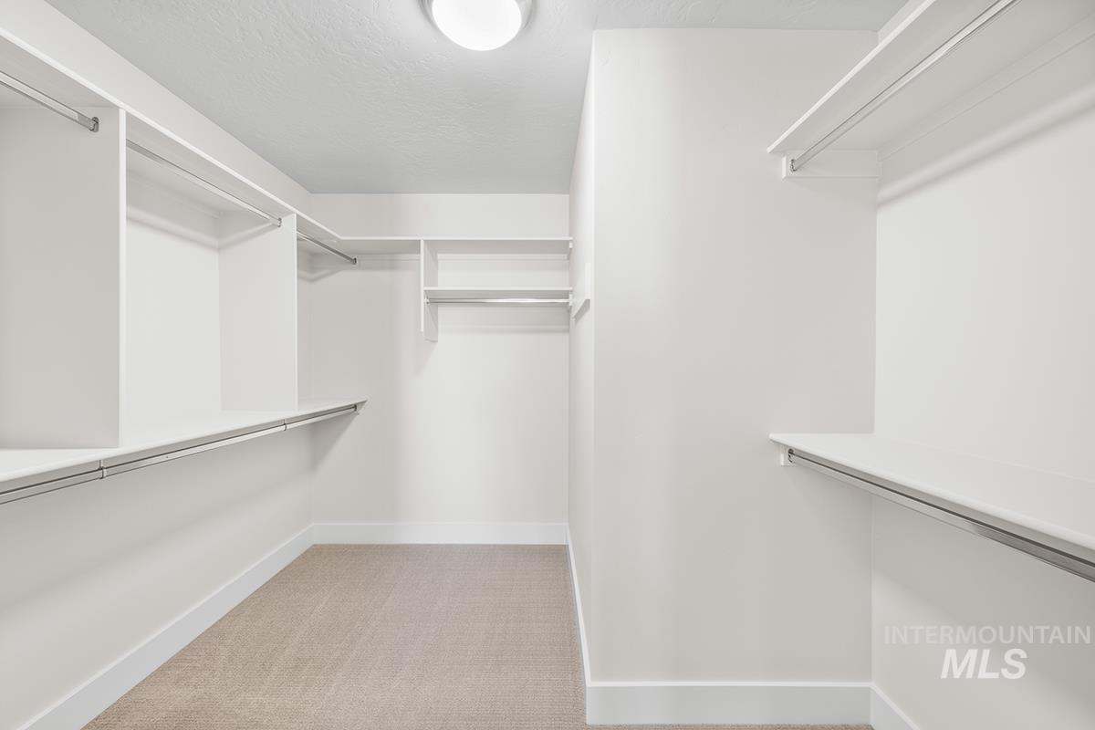 6983 South Skybreak Lane Meridian, ID 83642 - Photo 11 of 25 Walk in closet featuring light carpet