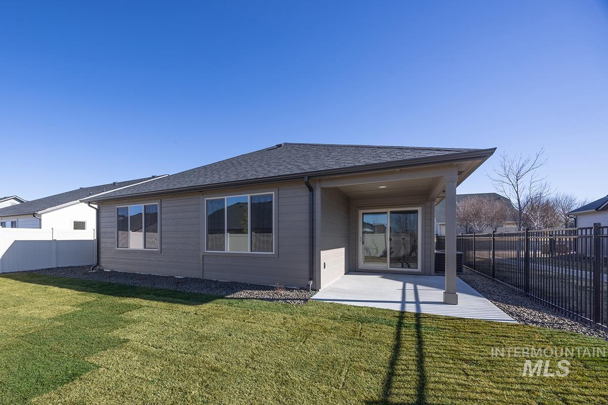 6983 South Skybreak Lane Meridian, ID 83642 - Photo 16 of 25 Rear view of property with a fenced backyard, a patio, and roof with shingles