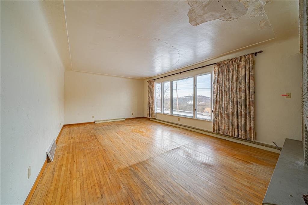 1316 Ridge Road Belle Vernon, PA 15012 - Photo 18 of 21 wooden floor in an empty room with a window