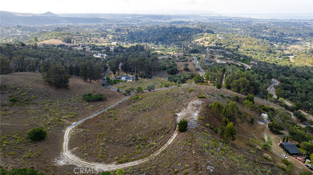 1190 Montecito Ridge Drive Arroyo Grande, CA 93420 - Photo 3 of 10 a view of a wooden house with a mountain and trees in the background