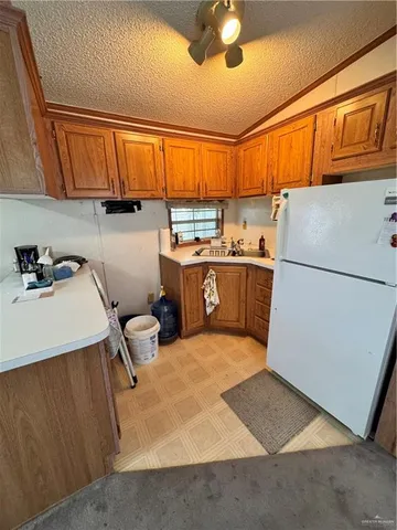 a kitchen with a refrigerator and a sink