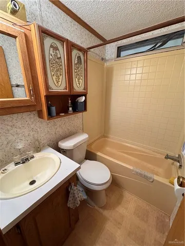 a bathroom with a sink a toilet and shower curtain