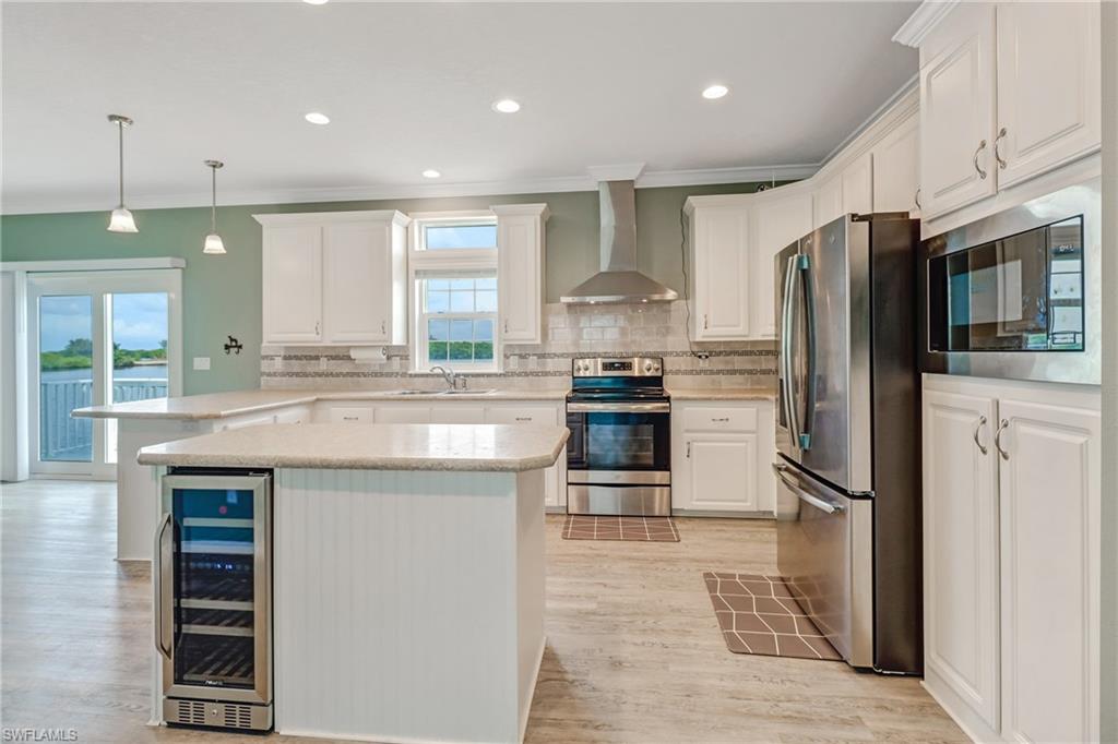 4835 East Riverside Drive Fort Myers, FL 33905 - Photo 14 of 35 a kitchen with granite countertop a refrigerator stove and oven