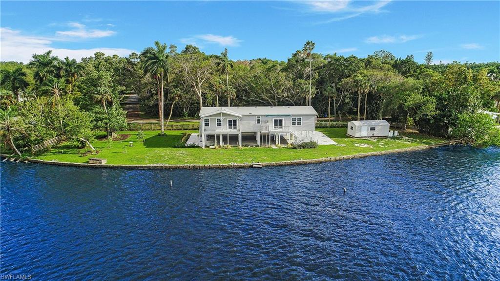 4835 East Riverside Drive Fort Myers, FL 33905 - Photo 19 of 35 a view of a swimming pool with an outdoor space and seating area