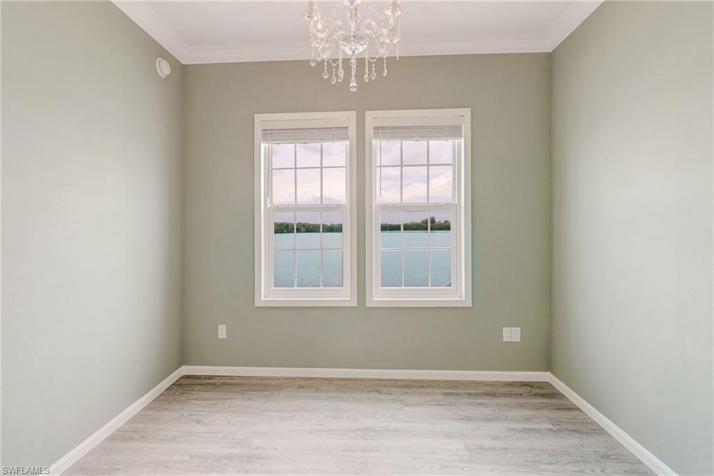 4835 East Riverside Drive Fort Myers, FL 33905 - Photo 24 of 35 an empty room with chandelier fan and windows