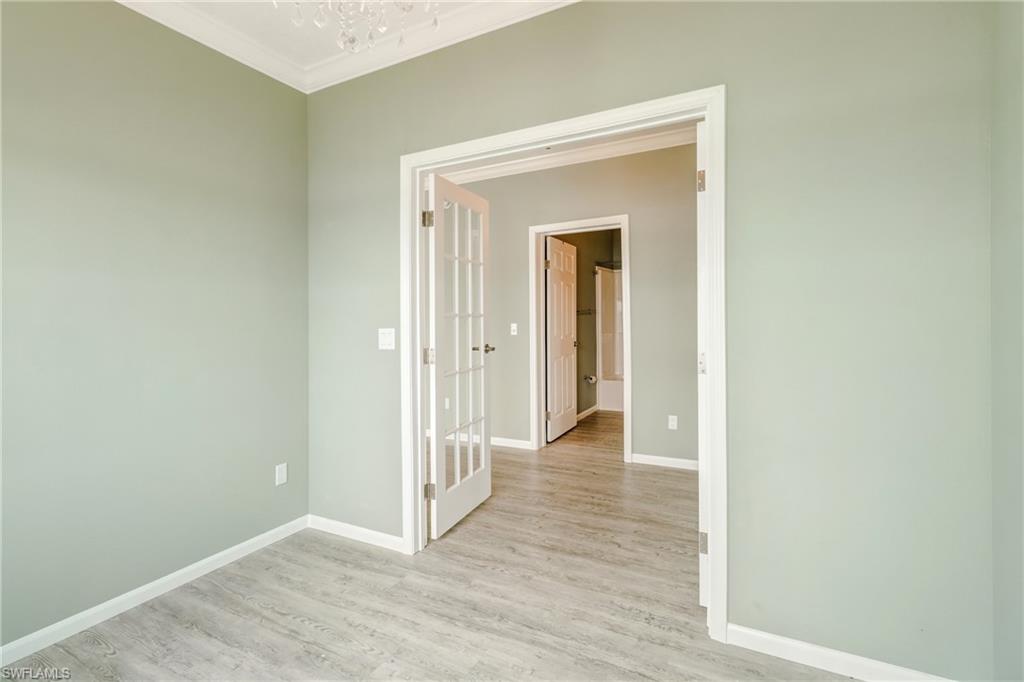 4835 East Riverside Drive Fort Myers, FL 33905 - Photo 25 of 35 a view of a hallway with wooden floor