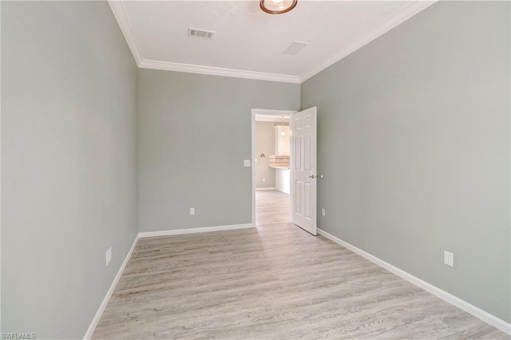4835 East Riverside Drive Fort Myers, FL 33905 - Photo 29 of 35 a view of an empty room with wooden floor