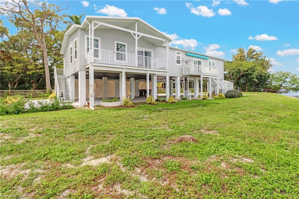 4835 East Riverside Drive Fort Myers, FL 33905 - Photo 3 of 35 a front view of a building with a garden