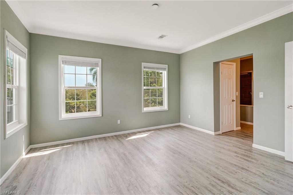 4835 East Riverside Drive Fort Myers, FL 33905 - Photo 31 of 35 an empty room with wooden floor and windows