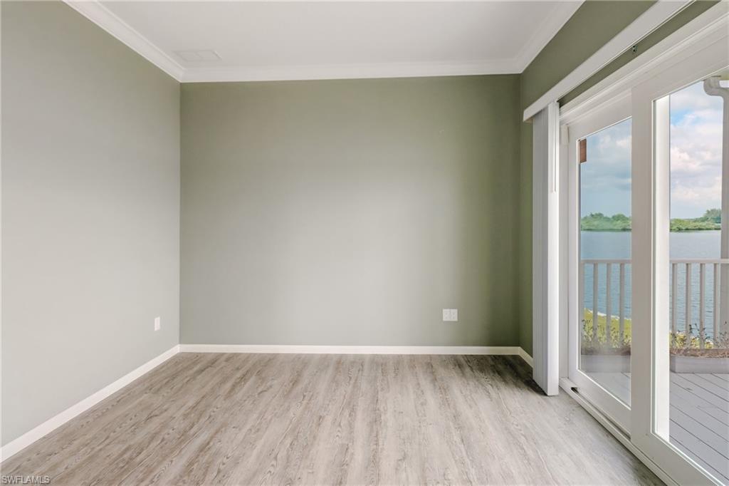 4835 East Riverside Drive Fort Myers, FL 33905 - Photo 32 of 35 an empty room with wooden floor and windows