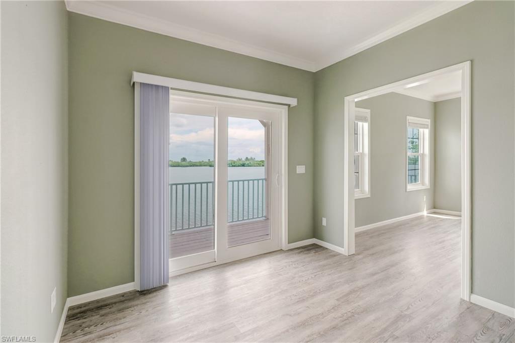 4835 East Riverside Drive Fort Myers, FL 33905 - Photo 33 of 35 an empty room with wooden floor and windows