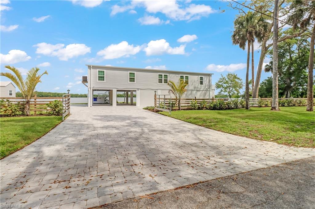 4835 East Riverside Drive Fort Myers, FL 33905 - Photo 7 of 35 a view of a house with a yard