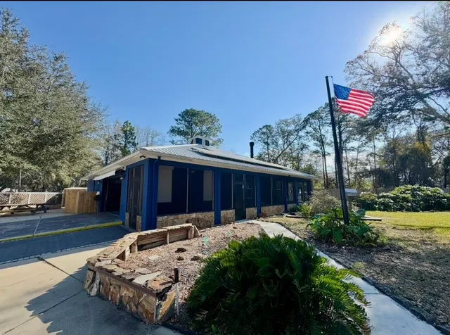 a wooden bench sitting in front of a house
